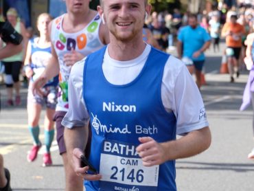 A man running wearing a Bath Mind vest