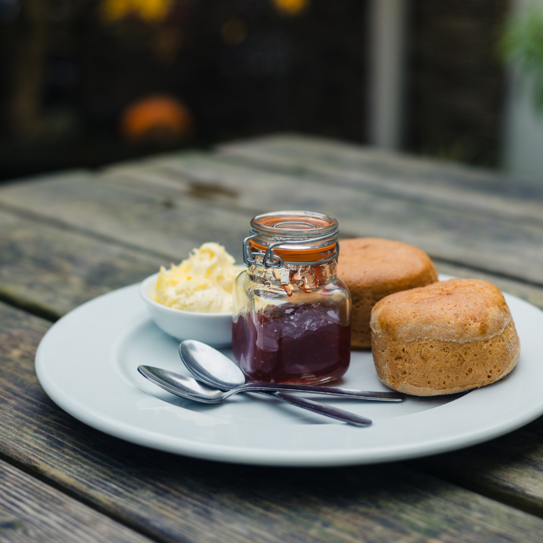 plate with scones, cream and jam on