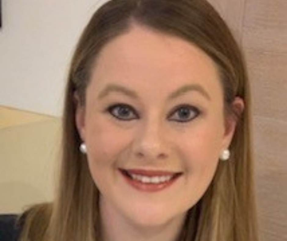 portrait of a white woman with blonde hair and pearl earrings