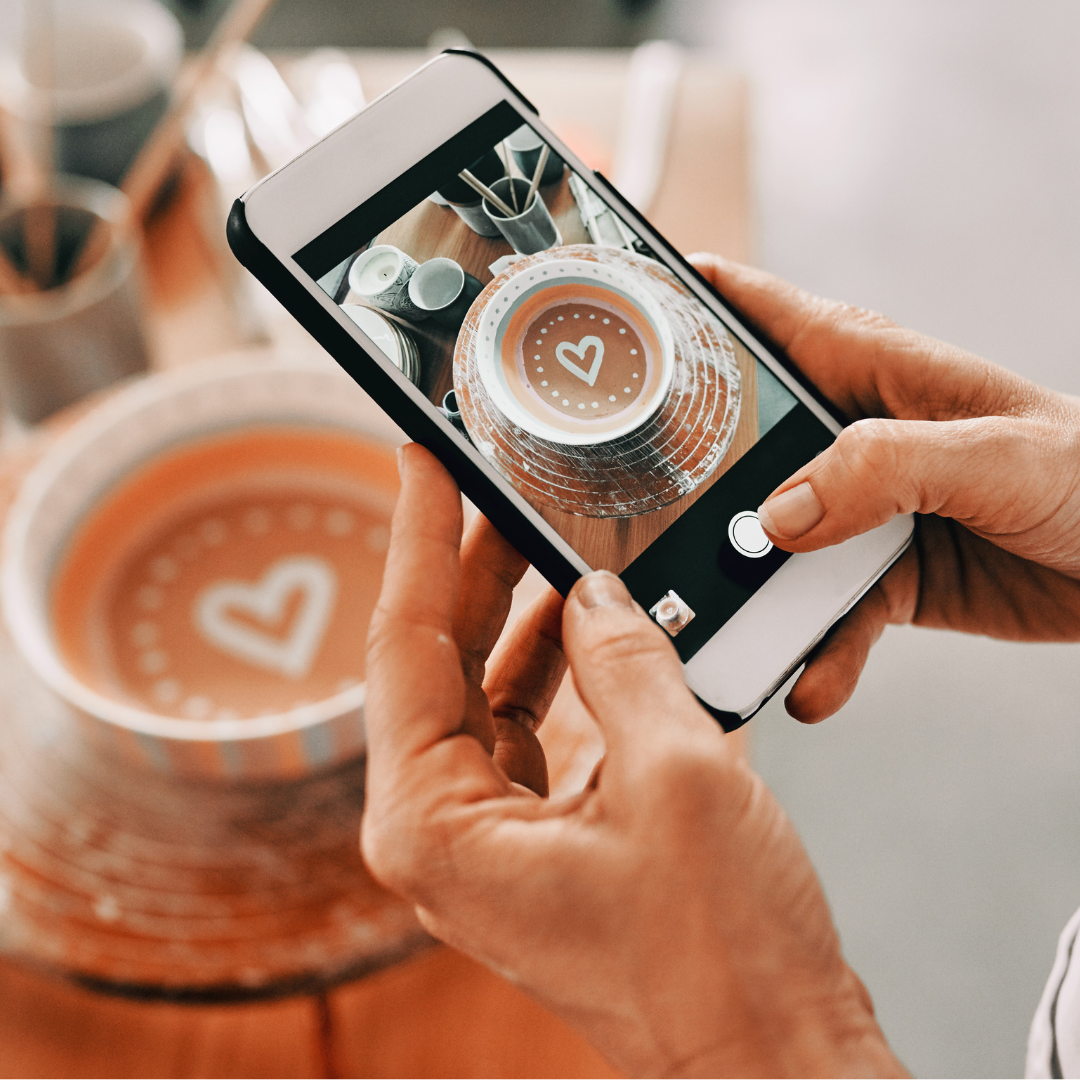 someone taking a photo of their pottery