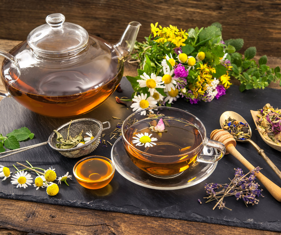a see through tea pot with herbal tea brewing