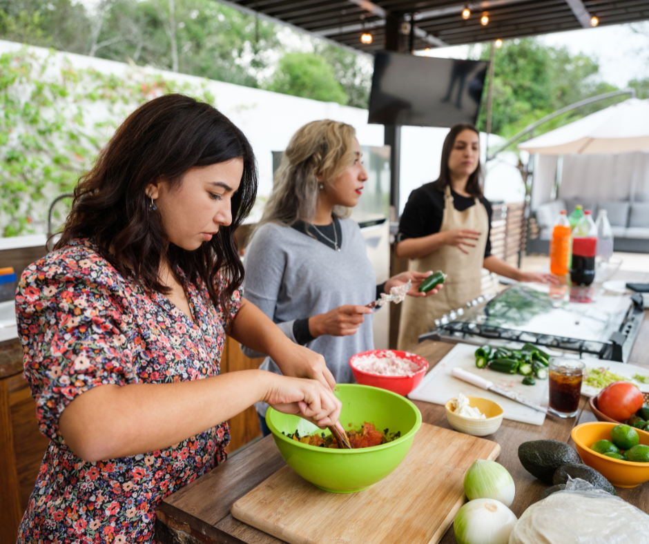 three people sat down preparing food together