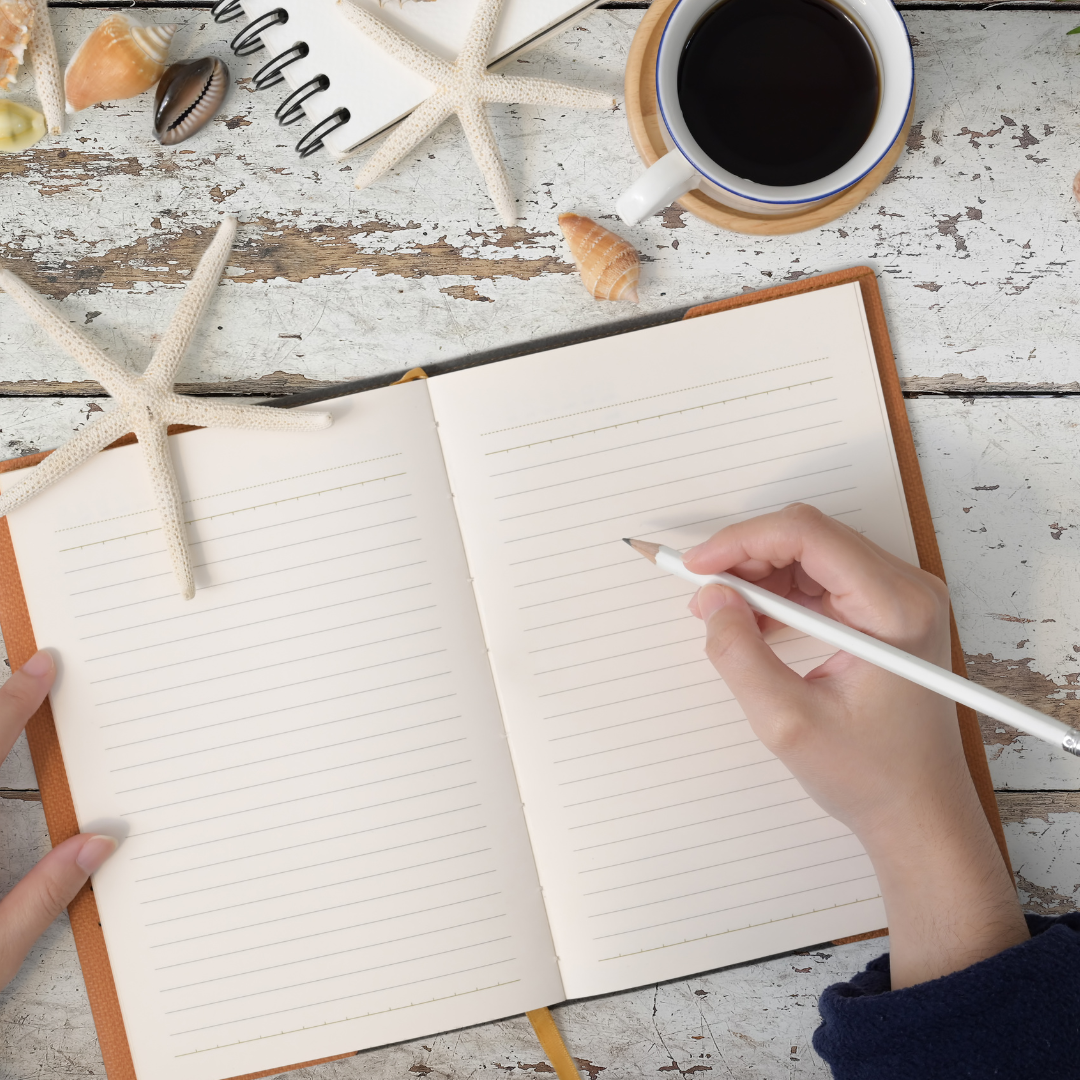 A hand holding a pencil and a notepad.