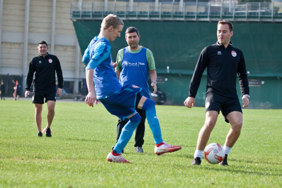 An action shot of a football match at Bath Mind's football wellbeing group