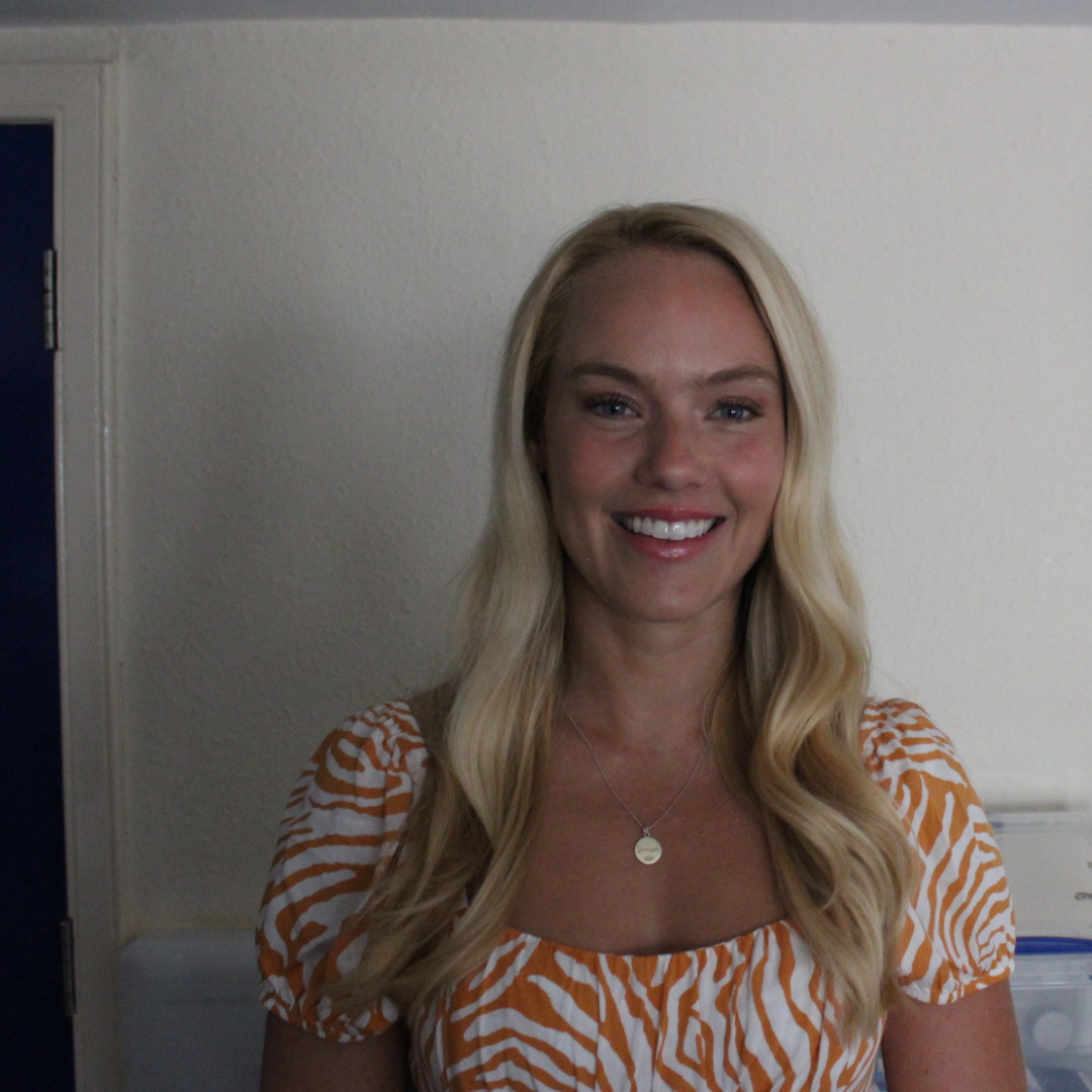 Portrait of a white woman with blonde wavy hair smiling