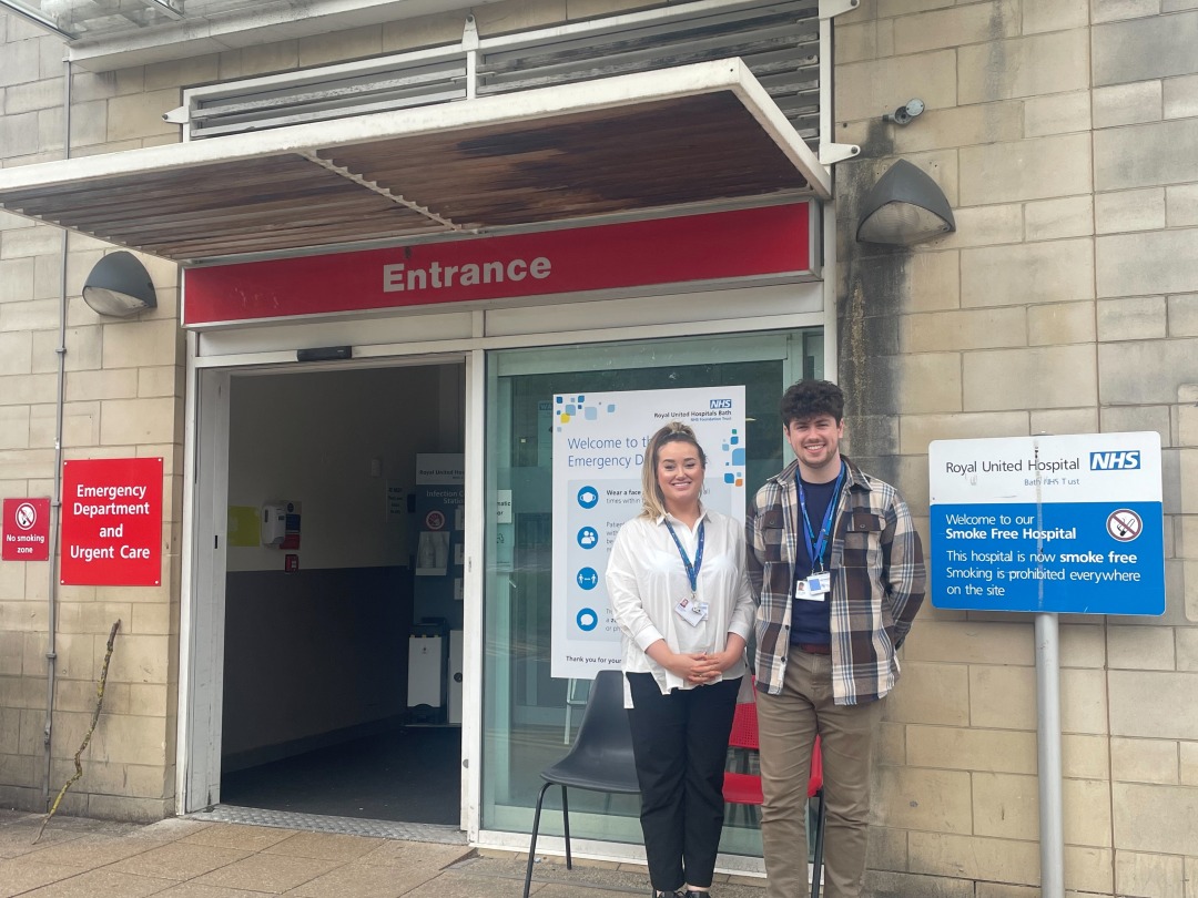 A woman and man stand outside the RUH Bath's Emergency Department
