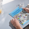 Hands opening Bath Mind's Colouring Wellbeing book ready to colour!