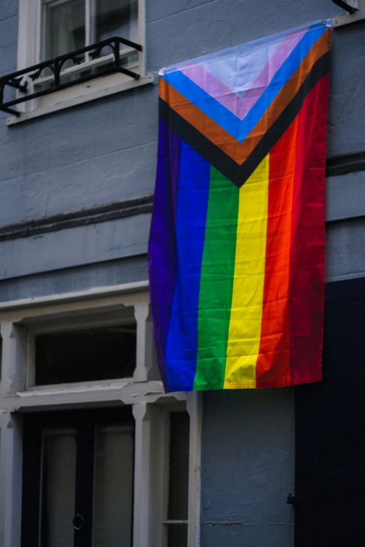 Pride flag hanging out a window