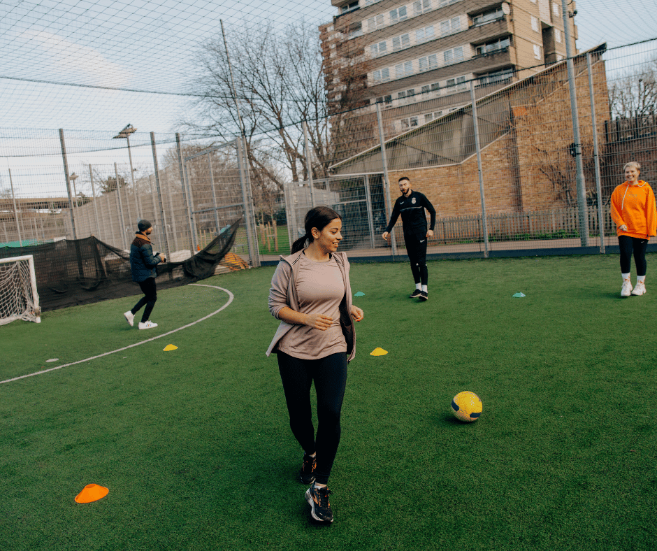 A group of people play football in a city