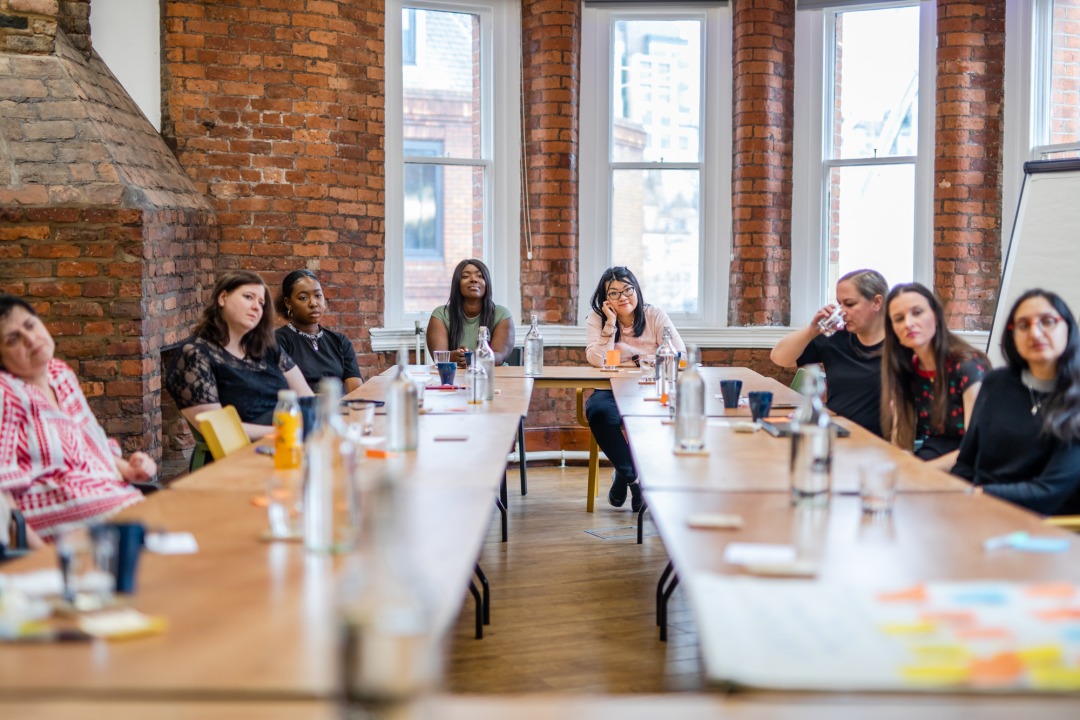 People sat around a table training with Bath Mind