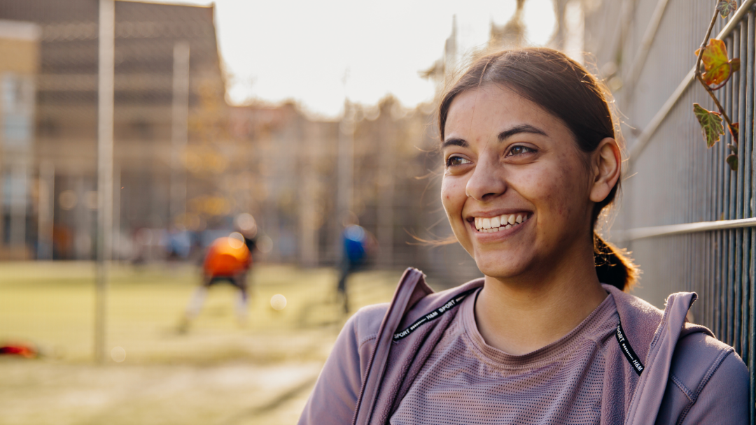 A woman standing outside smiling