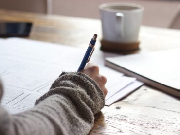 A hand writing on notebooks