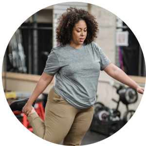 A black woman warming up at the gym