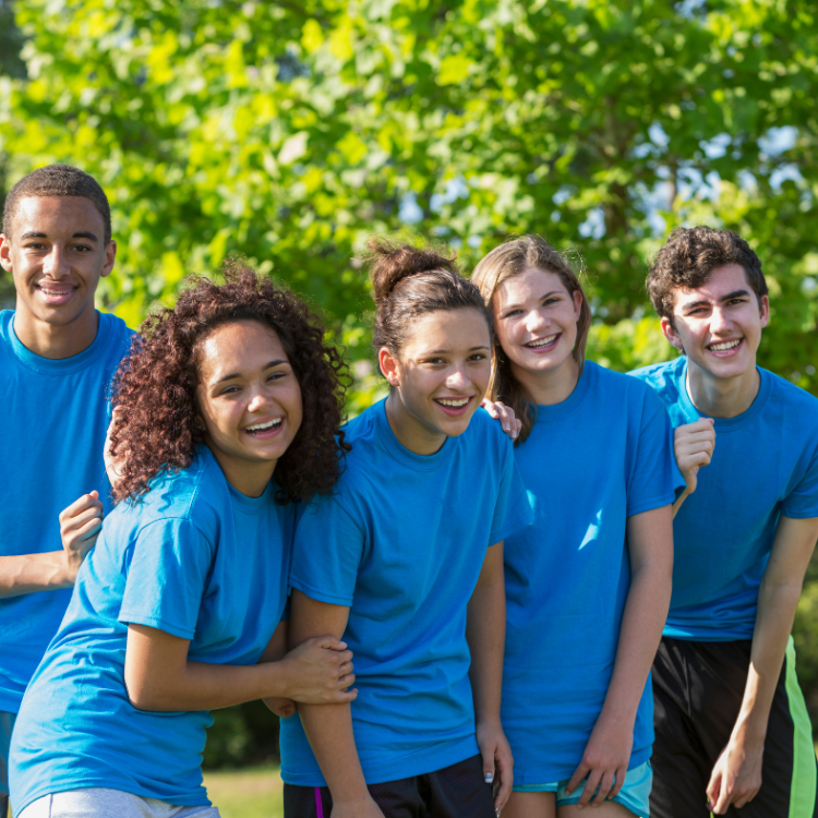 teenagers dressed in blue in a park