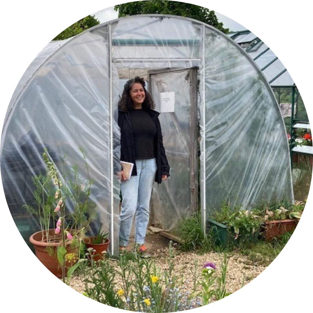 Bath Mind Greenlinks staff member stood in front of a greenhouse