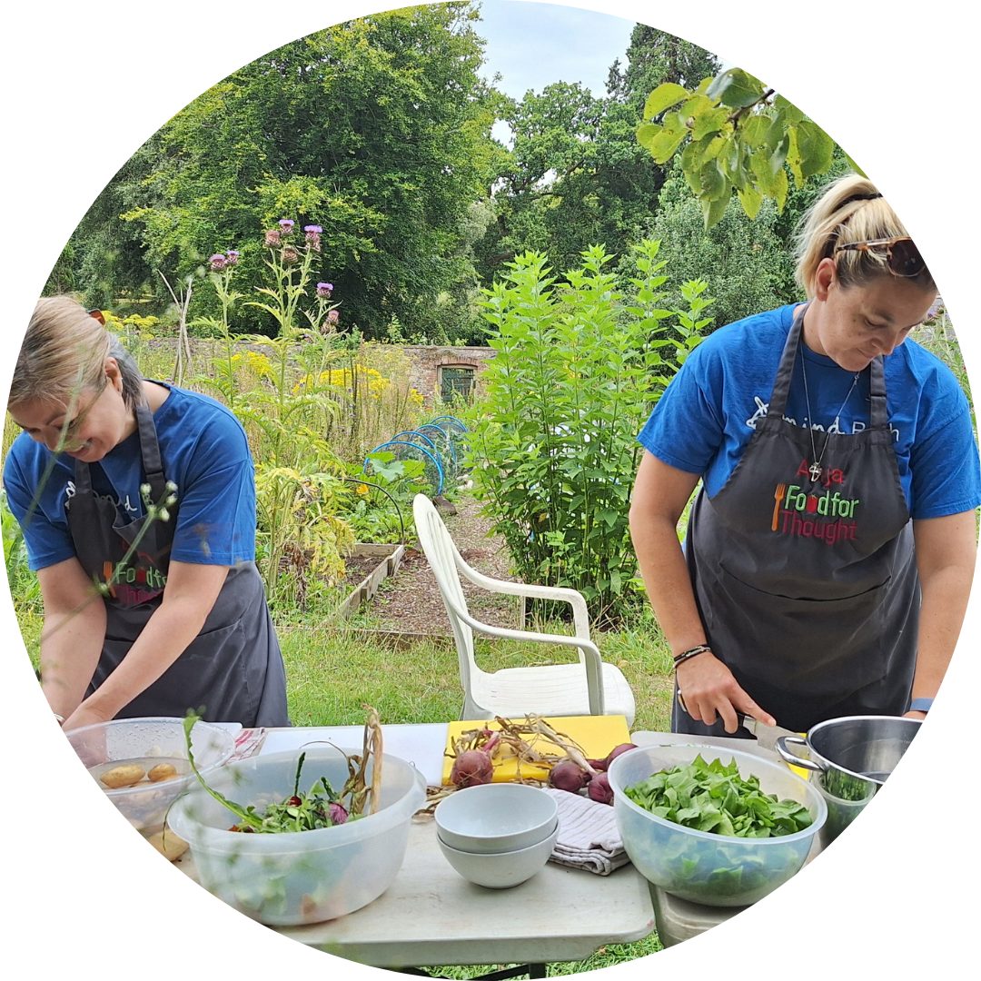Lydia and Anja from Bath Mind cooking in an allotment