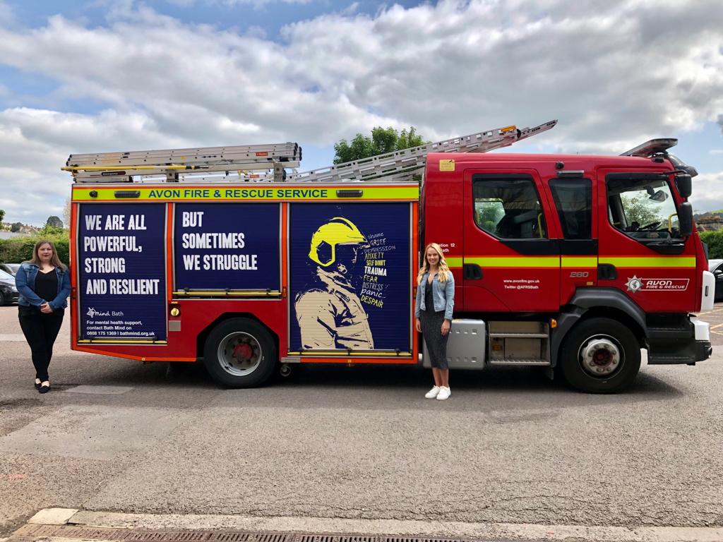 A fire truck with Bath Mind staff stood next to it