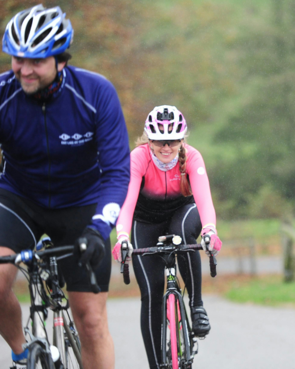 Two people on bicycles cycling on a road
