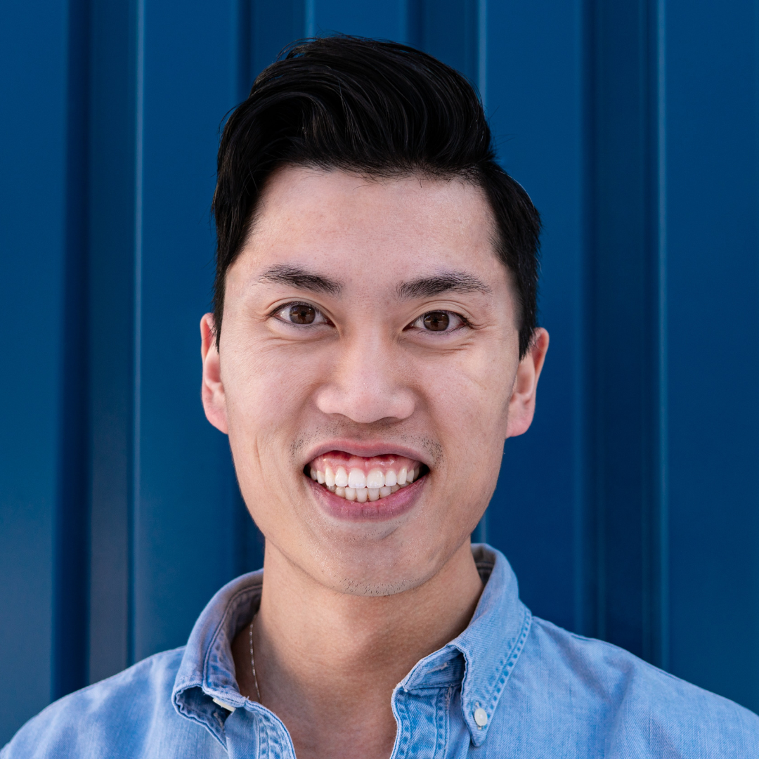 A man wearing a blue shirt smiling