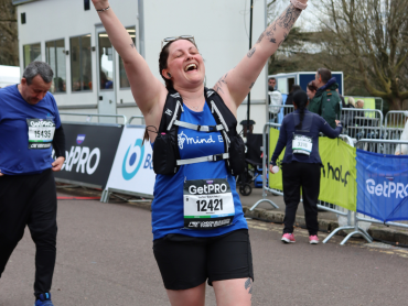 A woman crossing the Bath Half finishing line