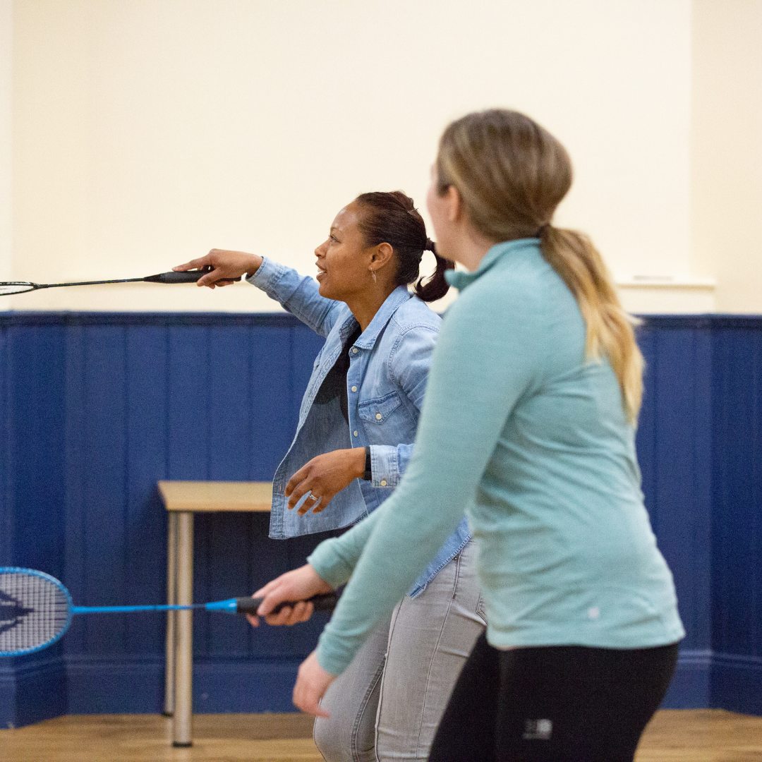 Two people playing badminton